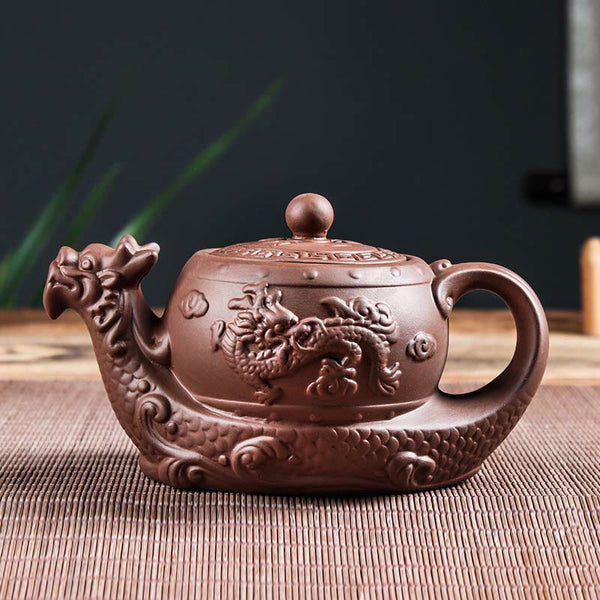 Vintage Dragon Auspicious Clouds Teapot – dragon head spout teapot on bamboo mat with plant accents, traditional zisha clay