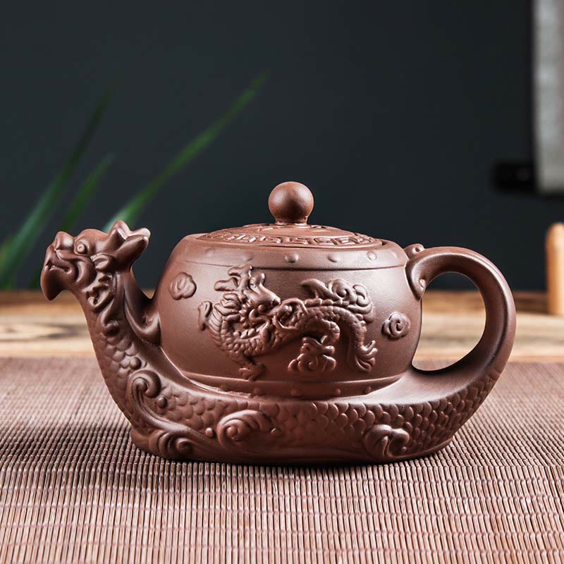 Vintage Dragon Auspicious Clouds Teapot – dragon head spout teapot on bamboo mat with plant accents, traditional zisha clay