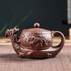 Vintage Dragon Auspicious Clouds Teapot – dragon head spout teapot on bamboo mat with plant accents, traditional zisha clay
