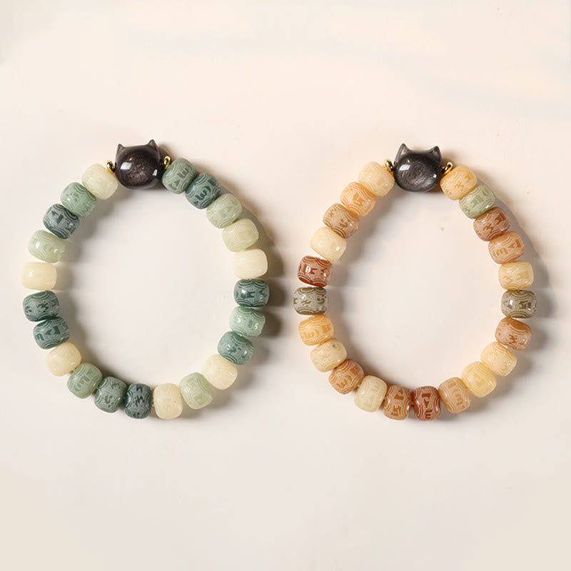 Bodhi Seed Cat Head Bracelet – Two bracelets side by side showing cool green and warm peach color options, both with black cat head charms