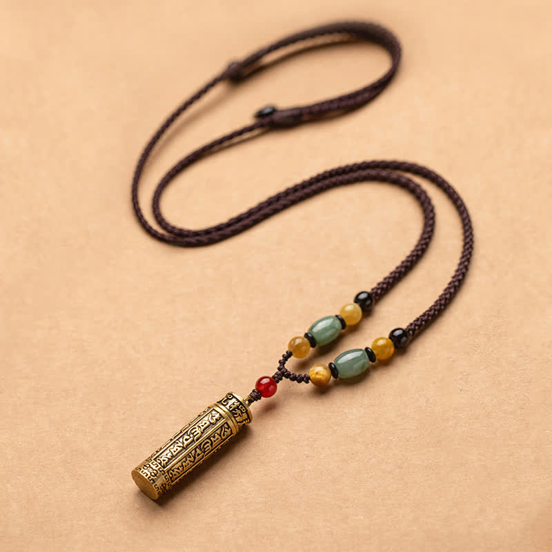 Tibetan Buddhist mantra cylinder pendant necklace with green aventurine, amber, and red carnelian beads on adjustable brown braided cord