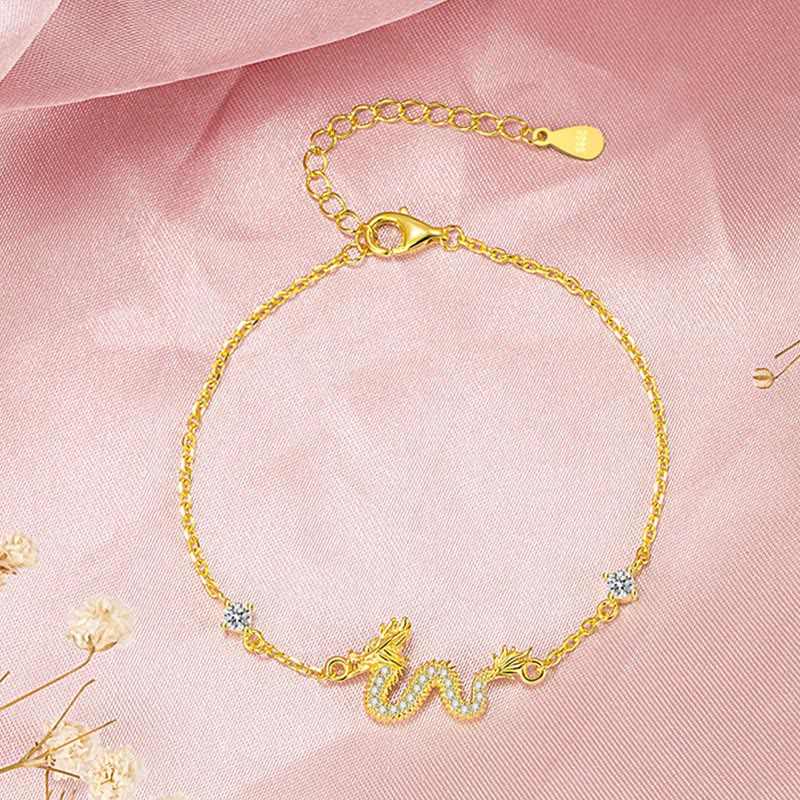 925 Silver Dragon Bracelet - Gold chain dragon flat lay on pink silk, zodiac gift