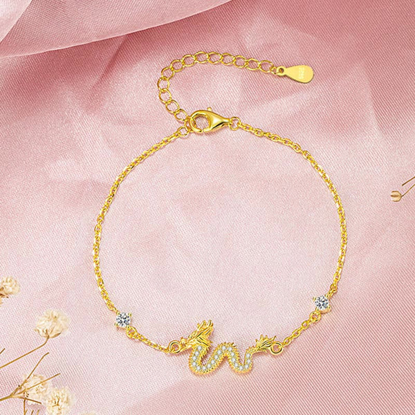 925 Silver Dragon Bracelet - Gold chain dragon flat lay on pink silk, zodiac gift