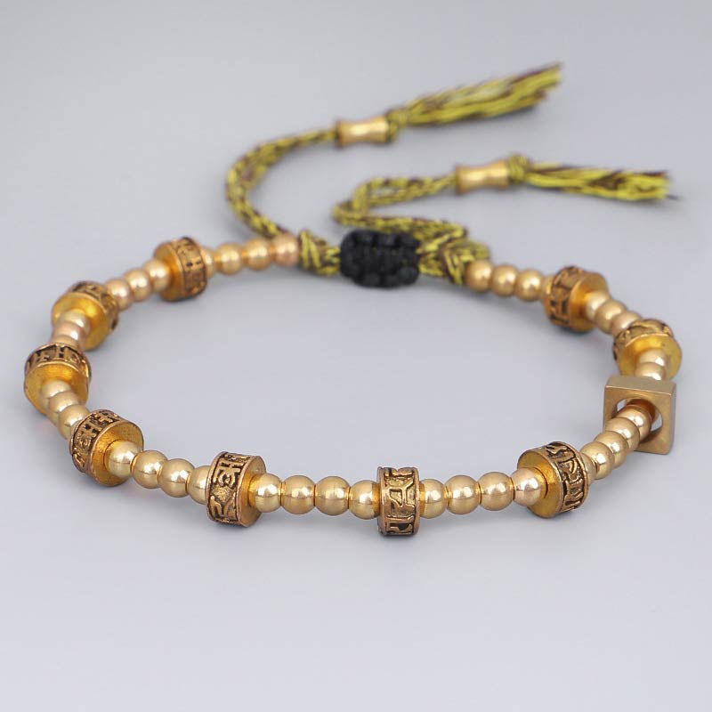 Tibetan Gold Om Mani Padme Hum Bracelet – Aerial view with black onyx accent bead, spiritual bracelet