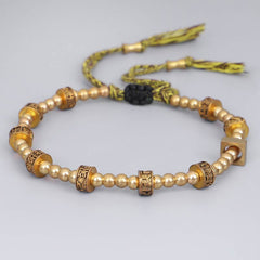 Tibetan Gold Om Mani Padme Hum Bracelet – Aerial view with black onyx accent bead, spiritual bracelet