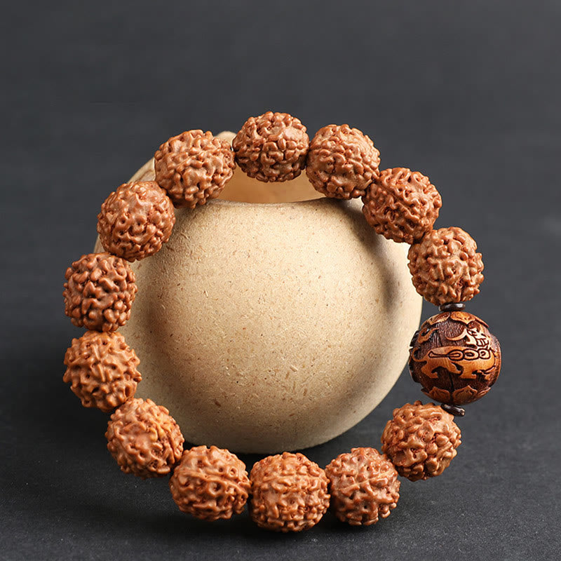 Rudraksha PiXiu Bracelet – Wrapped around beige ceramic jar, dark background, spiritual jewelry