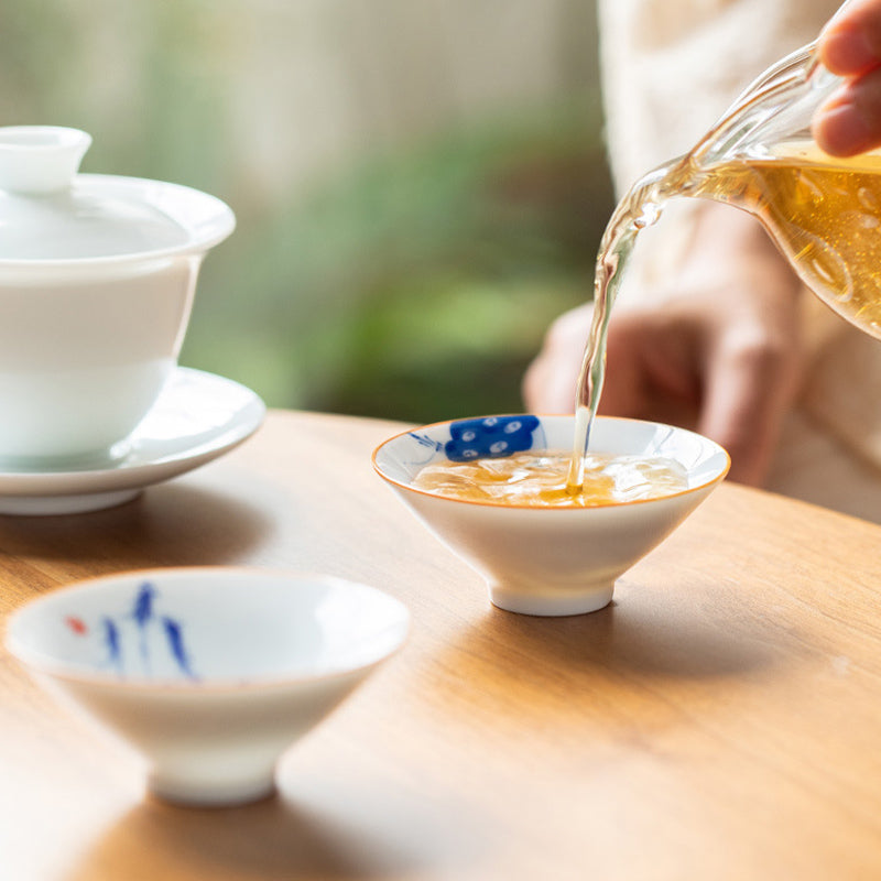 Mandala Koi Teacup – Held in hand showing 50ml size and ergonomic shape