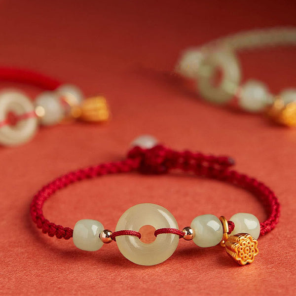 Jade Peace Buckle Lotus Bracelet – front view showing jade bi disc and translucent beads on crimson cord, Prosperity