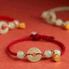 Jade Peace Buckle Lotus Bracelet – front view showing jade bi disc and translucent beads on crimson cord, Prosperity