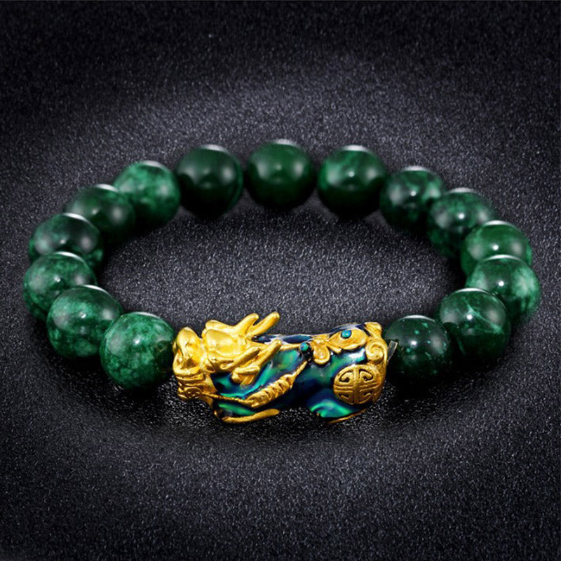 PiXiu Jade Bracelet – On reflective black surface with green jade beads and gold PiXiu charm