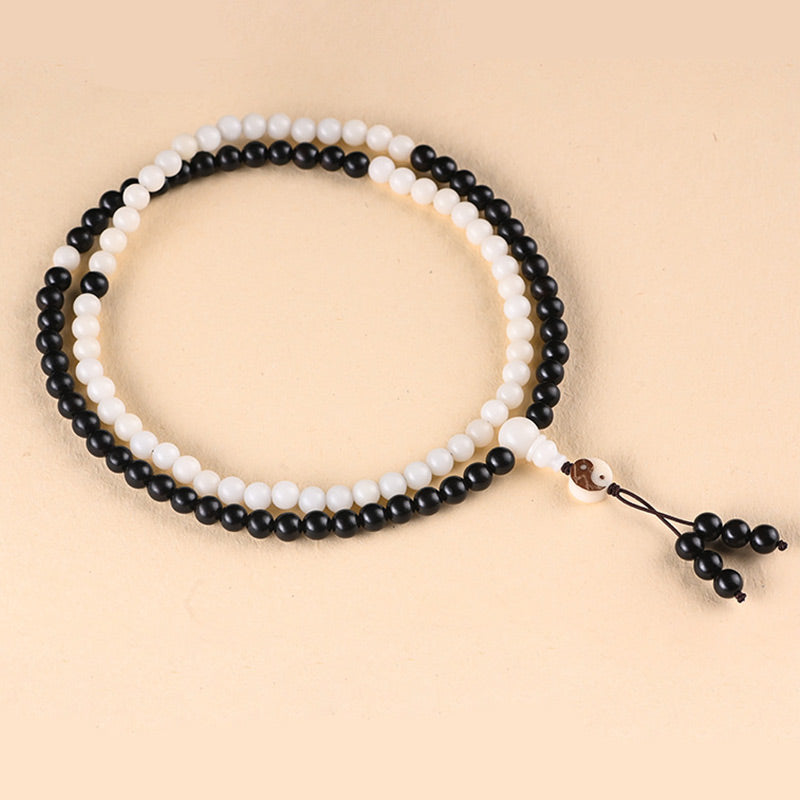 Ebony Yin Yang Protection Mala - obsidian and white bead prayer strands on beige, mindfulness mala