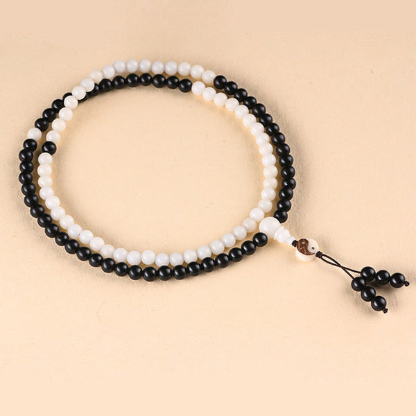 Ebony Yin Yang Protection Mala - obsidian and white bead prayer strands on beige, mindfulness mala
