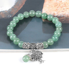 Tree of Life aventurine bracelet with pale green translucent beads, antique silver Tree of Life charm, silver floral scroll spacer beads.