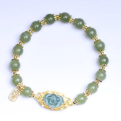 Hetian Jade Lotus Bracelet - top-down view on white background revealing full beaded design, lotus charm bracelet