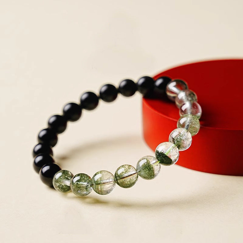 Obsidian Green Phantom Bracelet – propped on red stand, cream background, feng shui wealth energy
