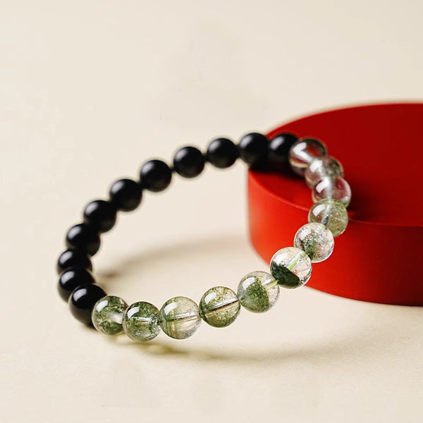 Obsidian Green Phantom Bracelet – propped on red stand, cream background, feng shui wealth energy