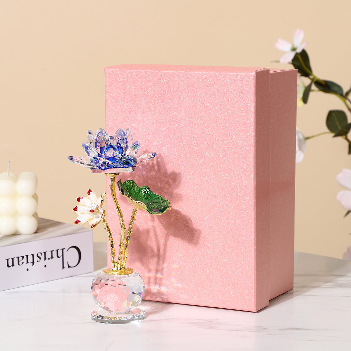 Crystal Lotus – blue crystal lotus beside pink gift box, product packaging presentation, feng shui wealth gift set