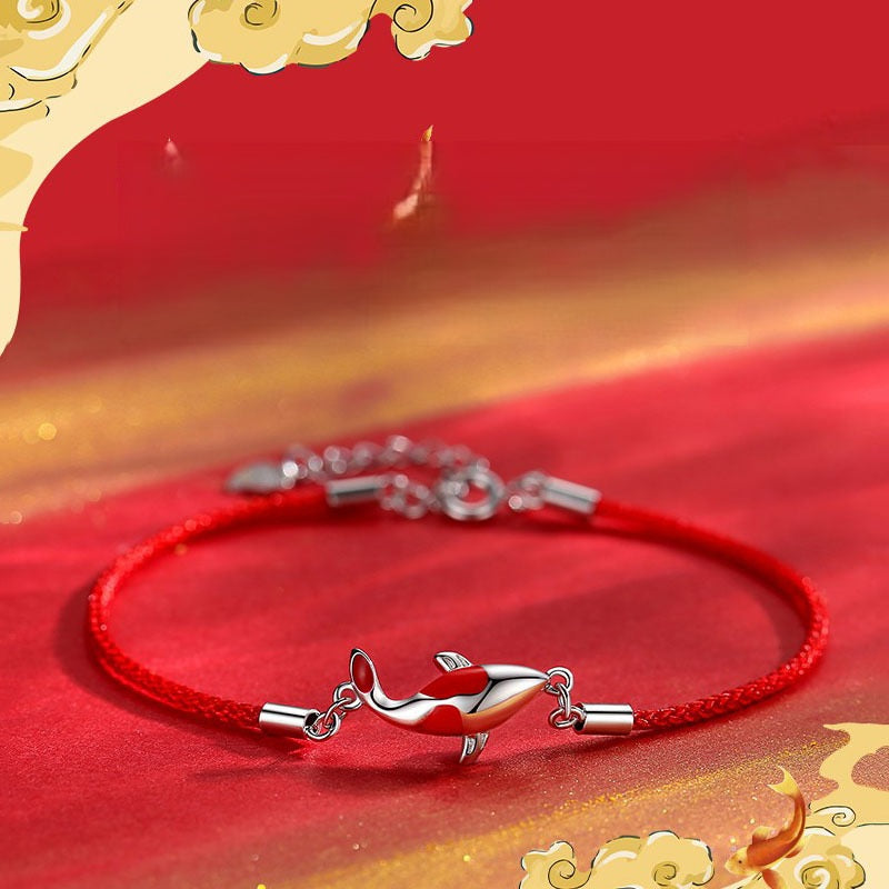 Koi Bracelet – red cord with silver koi fish on festive red and gold cloud background