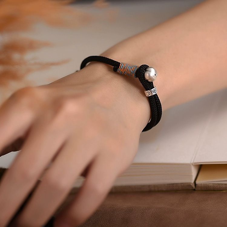 Persimmon Cord Bracelet – Black cord bracelet with silver persimmon bead on wrist, protection jewelry