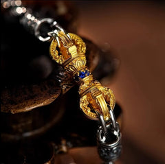Vajra Bracelet – macro close-up of gold vajra centerpiece with blue gemstone inlay, intricate detail