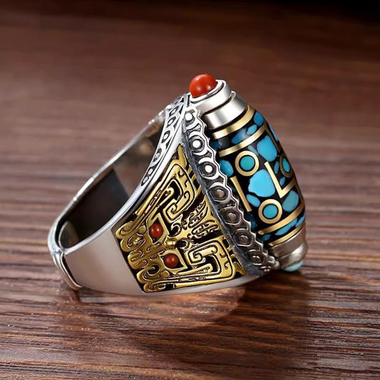 Dzi Bead Prayer Wheel Ring – side angle showing gold engraved patterns and red coral accent