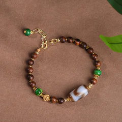 Dzi Rosewood Bracelet – Circular view of rosewood bracelet with gold clasp and dzi bead, Tibetan spiritual jewelry