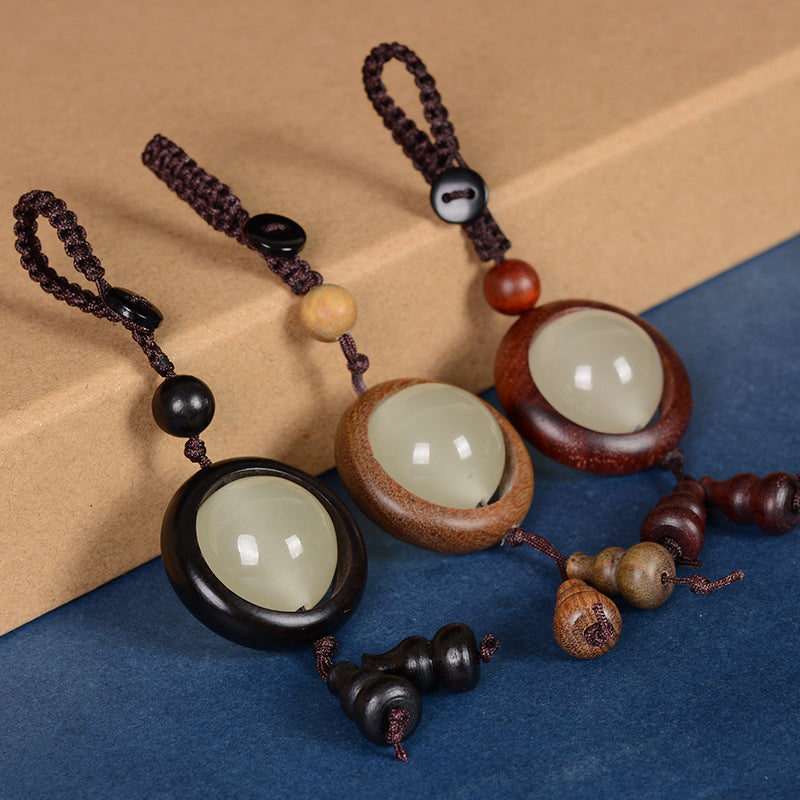 Feng Shui Sandalwood Keychain with Luminous Bead – Three keychains side by side on black background showing Ebony, Green Sandalwood, and Bloodwood