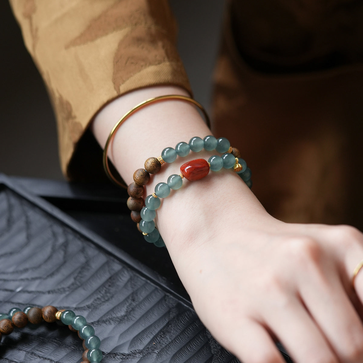 Blue Feicui Jade Two-Row Bracelet – lifestyle wrist shot with beige sleeve, jade and wood beads
