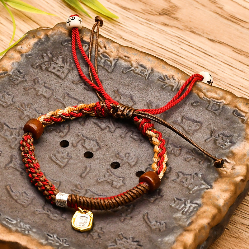 Tibetan Cord Bracelet – red woven cord with wood beads on engraved stone plate, meditation jewelry