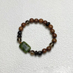 Sandalwood Wushi Bracelet – Overhead view of sandalwood bracelet with jade plaque and black obsidian beads