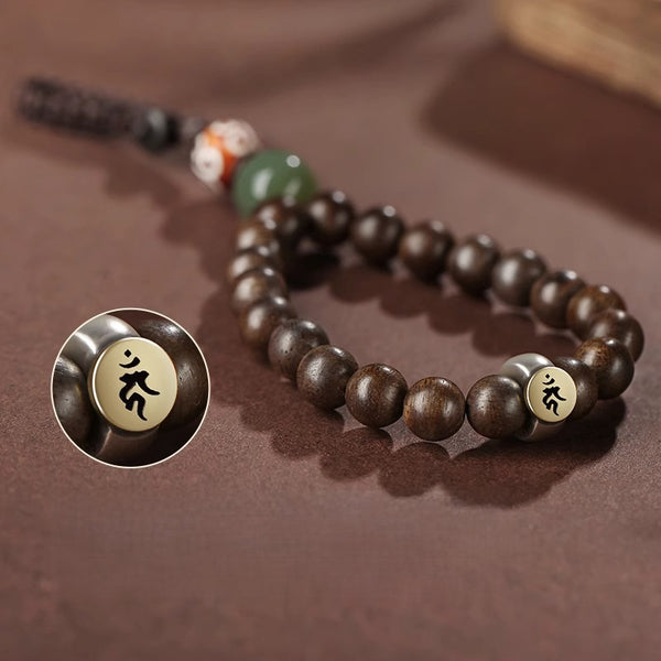 Hetian Jade & Agarwood Zodiac Buddha Keychain – Model holding car key fob with charm attached, showing real-life use and elegant drape