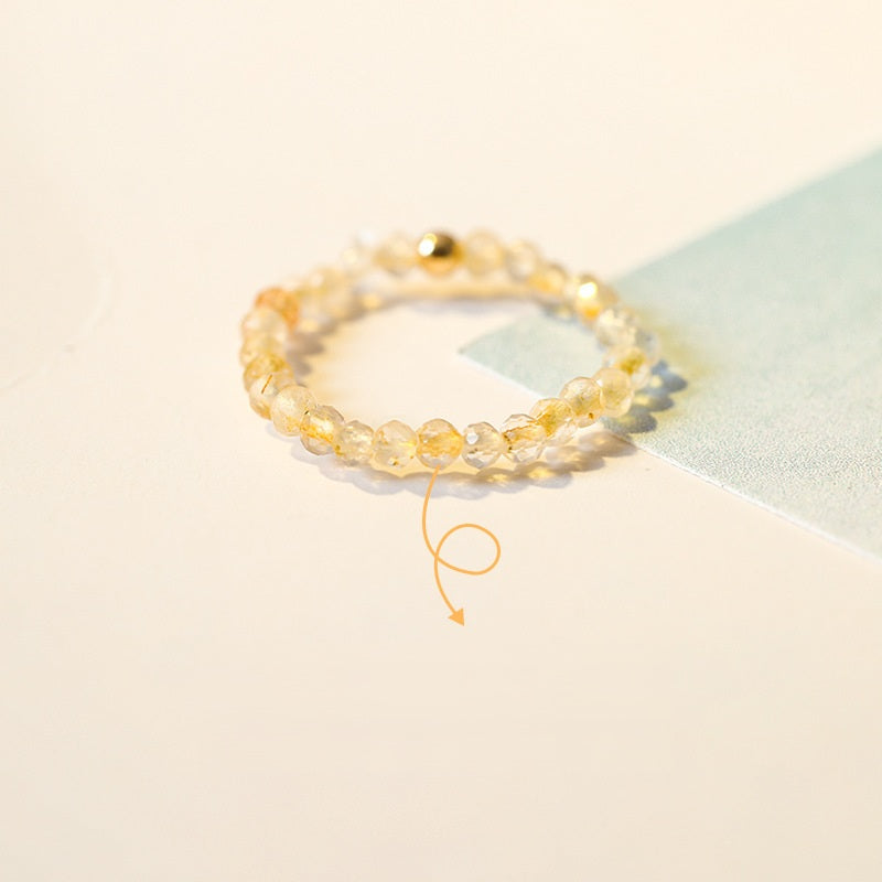 2mm Citrine Ring – Citrine beads with gold bead on cream and light blue card, wealth crystal ring