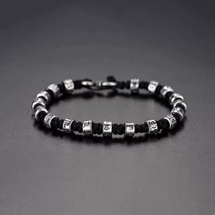 Zen Mantra Cord Bracelet – silver engraved mantra beads on black braided cord with S-hook clasp, dark gray background, mindfulness jewelry