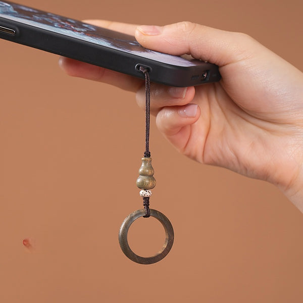 Sandalwood Phone Grip – Hand holding phone with green sandalwood ring grip on warm brown background, in-use lifestyle shot