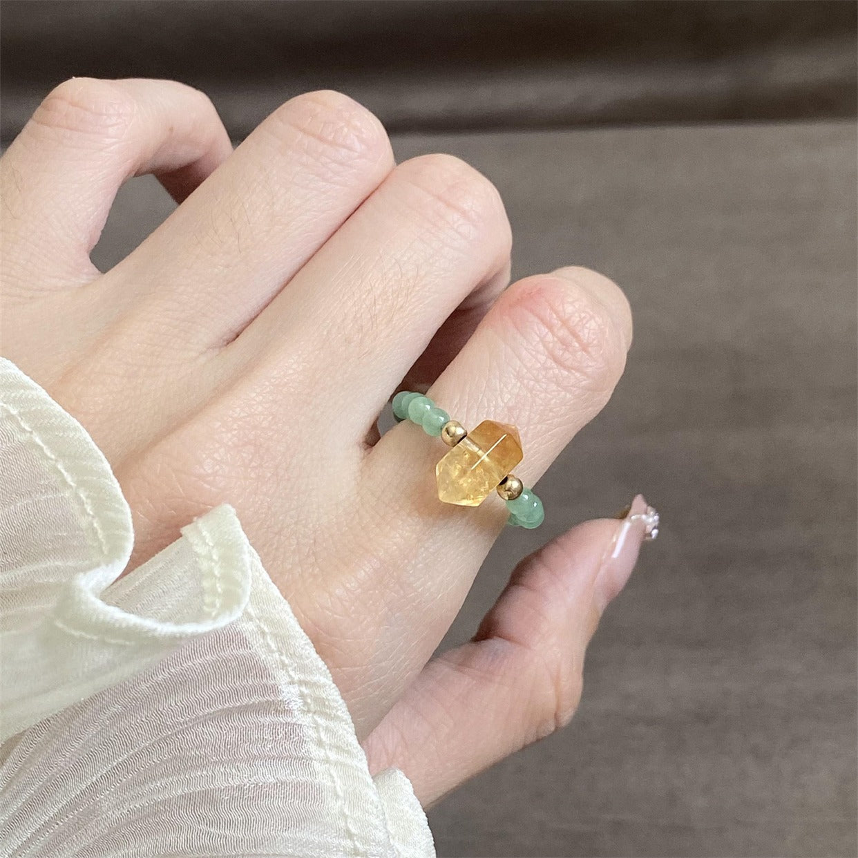 Citrine Aventurine Ring – Citrine crystal and green aventurine ring worn on finger with white sleeve, wealth ring