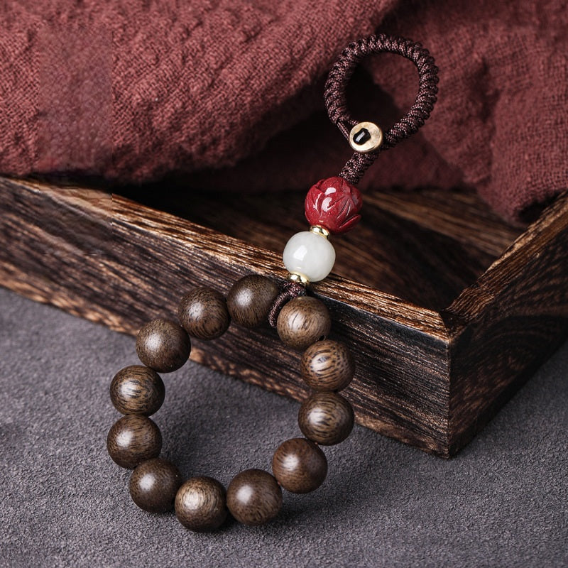 Agarwood & Hetian Jade Lotus Car Keychain, close-up detail, lucky charm