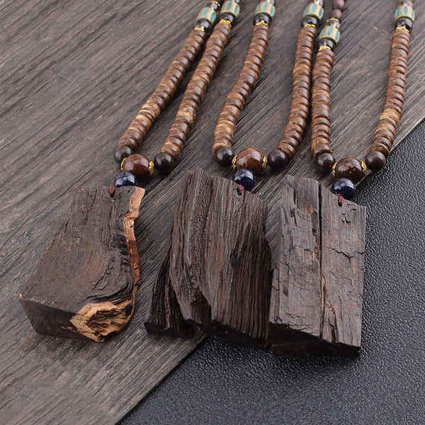 Wenge Wood Pendants – three raw wood slice pendants on beaded chains natural texture close-up, earthy decor