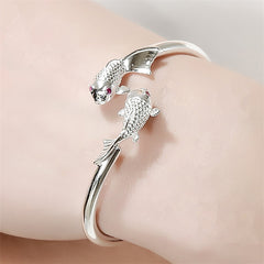 Double Fish Cuff – worn on wrist showing silver koi bracelet with textured fish scales