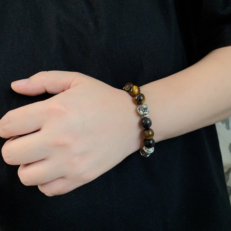 Tiger Eye Bracelet – Beaded bracelet worn on wrist against black fabric, casual luxury protection jewelry