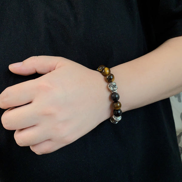 Tiger Eye Bracelet – Beaded bracelet worn on wrist against black fabric, casual luxury protection jewelry