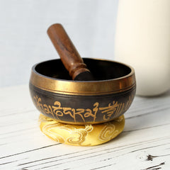 Tibetan Singing Bowl Set – Brass bowl with mallet on golden cushion, engraved mantra bowl