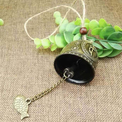 Feng Shui Wind Chime Bell - Angled view of engraved bronze bell with mystical script medallions, mindful decor