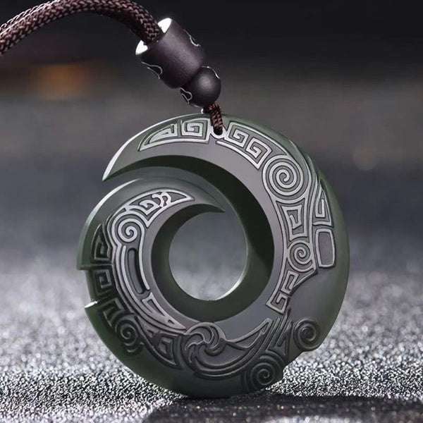 Hetian Cyan Jade Peace Buckle Luck Necklace – Dark green carved jade pendant with spiral cutout design, traditional cloud motifs, and black braided cord on dark background