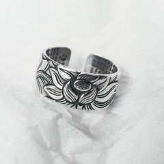 999 Silver Lotus Ring – oxidized lotus relief on white fabric, adjustable open cuff