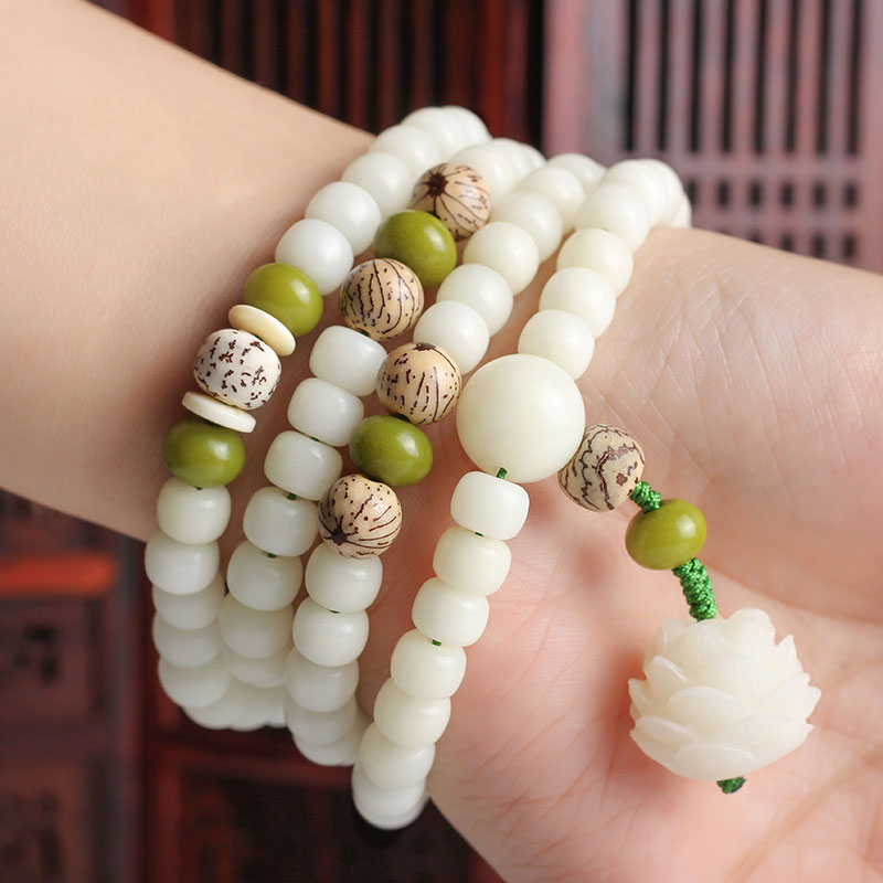 Bodhi Seed Lotus Mala - four-wrap bracelet on wrist with lotus pendant, Chinese lattice screen, wearable