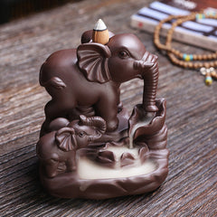 Elephant Purple Clay Incense Burner – Adult and calf elephants with backflow smoke on wooden table, zen decor