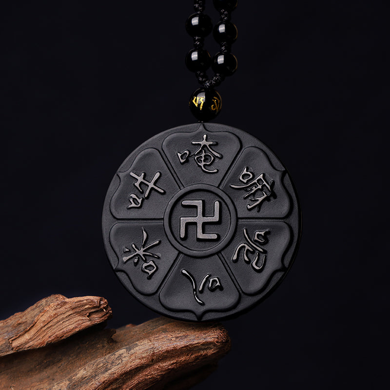 Black Obsidian Swastika Mantra Necklace - Frontal view on black, carved lotus pendant with swastika center, Buddhist amulet