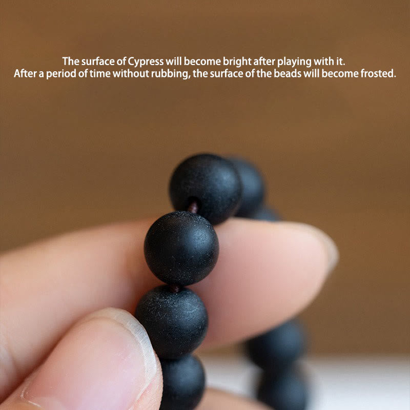 Tibetan Cypress Bodhi Lotus Bracelet - frosted cypress wood beads in hand, natural patina, grounding