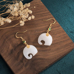 Feng Shui Elephant White Jade Fortune Earrings flat lay angle view