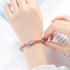 Moonstone PiXiu Bracelet – Bracelet worn on wrist over book page, everyday healing jewelry